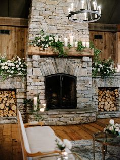 a stone fireplace with candles and flowers on it