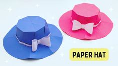 two paper hats with bow ties on them, one is pink and the other is blue