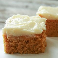 two pieces of carrot cake with white frosting