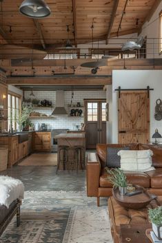 a living room filled with furniture next to a kitchen