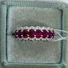 a diamond and ruby ring in a velvet box