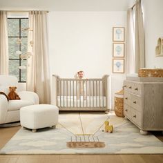 a baby's room with a crib, rocking chair and teddy bear