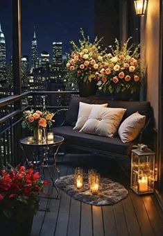 a balcony with flowers and candles on it