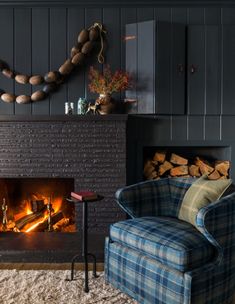 a living room filled with furniture and a fire place in front of a brick fireplace