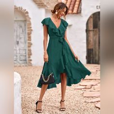 New Chic Ruffle Wrap Tie Midi Dress * Wrap Deep V Neckline * Ruffle Trim * High Waist * Belted Tie Waist * A Line Flare High Low Skirt * Ruffle Hem * Short Flutter Sleeve * Side Zip *Approximate Unstretched Measurements* Small (4) * Bust 35.25" * Waist 28.5" * Length 47" Medium (6) * Bust 37" * Waist 30" * Length 47.5" Large (8/10)* Bust 39.25" * Waist 32.5" * Length 48.25" Xl (12) * Bust 41.5" * Waist 35" * Length 49" On Order* Will Ship In 5-10 Days Fabric : Soft Flowy Poly Color : Dark Green Elegant Green V-neck Ruffle Dress, Elegant Green Dress With Ruffled Skirt, Chic Green Dress With Ruffles, Chiffon Ruffle Dress Midi Length, Chiffon Midi Ruffle Dress, Elegant Beach Midi Dress With Ruffled Skirt, Midi-length Chiffon Ruffle Dress, Chiffon Midi Ruffle Dress With Ruffle Hem, Elegant Midi Dress With Ruffle Hem For Vacation