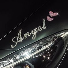 a car with the word angel written on it's front grill and lights behind it