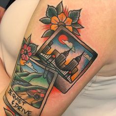 a woman with a tattoo on her arm that has an image of a truck and flowers