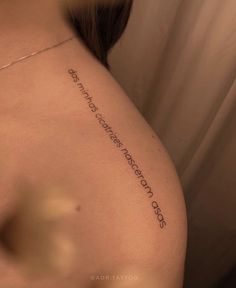 the back of a woman's shoulder with an inscription on it