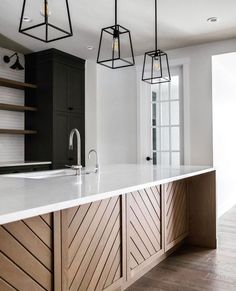 a kitchen with white counter tops and wooden cabinets