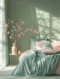 a bedroom with green walls and pink flowers in the vases on the side of the bed