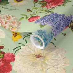 a flowered wallpaper with flowers on it and a roll of tape in the middle