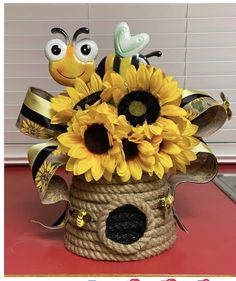 a basket filled with sunflowers and bees on top of a table