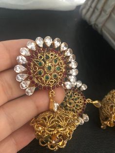 Complete your look this festive season with our beautiful dubble layer jhumka earrings with semi precious ruby and emerald stones and kundan work. A gorgeous pair of jhumka earrings to light up your day any time! In stock and ready to ship. Temple Jewelry Style Jhumkas With Latkans For Party, Temple Jewelry Style Jhumkas For Party, Temple Jewelry Jhumkas For Party, Festive Round Jhumkas With Stone Work, Temple Jewelry Style Party Jhumkas, Red Kundan Jhumkas With Intricate Design, Kundan Jhumkas For Festive Occasions, Bollywood Festive Jhumkas Dangle Earrings, Ornate Kundan Jhumkas For Festive Occasions