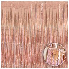 a close up view of a pink and gold curtain with fringes on the side