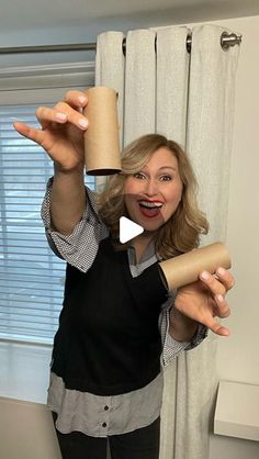 a woman holding a roll of toilet paper in front of her face