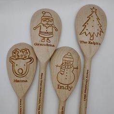 four wooden spoons with christmas designs on them