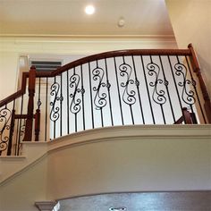 a stair case with wrought iron railing and handrail