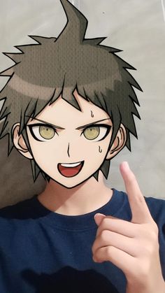 an anime character with green eyes pointing at the camera while wearing a blue t - shirt