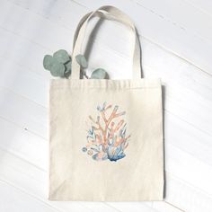 "Our popular canvas market tote with this beautiful design is printed to order using vibrant water-based inks in rural Wisconsin. ITEM DETAILS 12 oz. heavy duty canvas fabric 13 in. strap drop Reinforced webbing straps Digitally printed with eco-friendly inks, not vinyl transfer Dimensions: 14\" tall, 14\" wide, 5\" deep All photos and designs (C) 2023, American Life Brands." Eco-friendly Hand Painted Canvas Bag, Eco-friendly Hand Painted Rectangular Canvas Bag, Coastal Clothing, Coral Watercolor, American Life, Vinyl Transfer, Market Tote, Market Bag, Reusable Bags