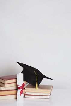 a graduation cap sitting on top of books