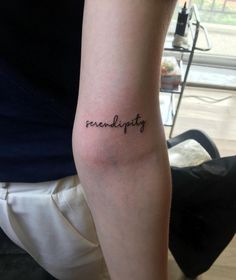 a person with a tattoo on their arm that reads, reinefpity in cursive writing