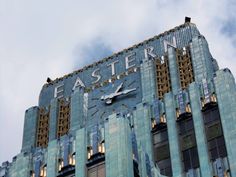 a large building with a clock on the front and side of it's face