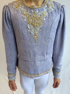 a mannequin wearing a blue top with gold sequins on it's chest