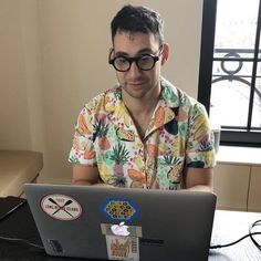 a man sitting in front of a laptop computer