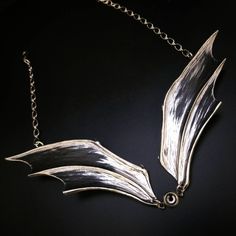 "Lead-free pewter handcrafted bat wings with center options & Swarovski crystals. See numbered options in last pic. All adjust up to 18\"( if you need longer just tell us in the notes) Wings individually are 5\" x 1½\" Wing spread accross is 10½\" #1 Small center crystal is available in black, gray, or volcano (fiery color) Tell us your preference in the notes. #2 & 3 Horned crystal is 1\"x¾\" with Swarovski Rivoli 20mm crystal Gray or Vitrail (tell us in notes) #4 & 5 Bat skull 1¼ x Silver Fantasy Wing-shaped Jewelry, Fantasy Silver Wing-shaped Jewelry, Silver Wing-shaped Fantasy Jewelry, Silver Winged Fantasy Jewelry, Elegant Winged Metal Jewelry, Skull Collar, Crow Necklace, Bat Skull, Bat Jewelry