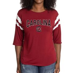 Elevate the style of your game day tee with this South Carolina Gamecocks Abigail Jersey T-shirt. It features the team name and logo accentuated by contrast-color side stitching and sleeve stripes. A rounded hem gives this South Carolina Gamecocks shirt a more comfortable fit and feel. Varsity Team-colored Tops For Game Day, Varsity Team-colored Fan Merchandise T-shirt, Varsity Team-colored T-shirt For Fans, Varsity Team-colored T-shirt For Fan Merchandise, Varsity Style Team-colored T-shirt For Fans, Varsity Jersey Tops For Fan Gear, Varsity Team Logo Jersey T-shirt, Varsity Tops With Team Logo For Fan Gear, Varsity Jersey T-shirt With Team Logo