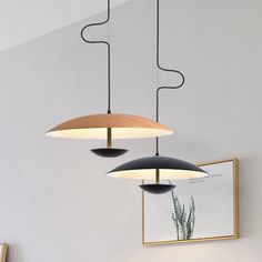 three lights hanging from the ceiling in a room