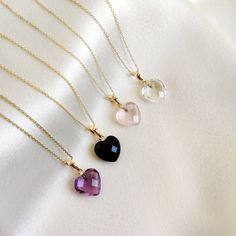 These dainty natural gemstone pendants in heart shape are a perfect addition to your necklace stack. Set in 14k Solid Yellow Gold, these charm pendants are unique and minimalist.  ITEM DETAILS * GEM 1. Purple Amethyst: 4.75 cts 2. Rose Quartz: 4.95 cts 3. Black Onyx: 5.00 cts 4. Clear quartz: 5.65 cts * Gem Size: 11x12mm * Gem Shape: Heart Briolette  * Gem Cut: Checker Cut * Gold Purity: 14K * Gold Weight: 0.37 gram * Gross Weight: 1.3 gram The Gold purity is guaranteed and it comes with authentic 14KT gold hallmark. Since my items are handmade, they are absolutely nickel and lead free. CUSTOMIZATION * Kindly choose your preferred gemstone from the drop-down option. Gemstone customisation is available as well, please message me for the same.  * Stone size customisation is also available. K Amethyst Heart Charm Pendant Necklace, Pink Heart Gemstone Pendant Necklace, Elegant Heart-shaped Amethyst Necklace, Valentine's Day Rose Quartz Heart Pendant Jewelry, Heart-shaped Amethyst Necklace For Valentine's Day, Handmade Jewelry Box, Heart Pendant Gold, Bezel Pendant, Heart Gemstone