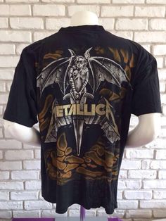 This is a great Metallica shirt from the early 90's The design is awesome, printed back and frontThere are a bunch of holes all over the shirt so please take a look at the picturesSize XL on tagPit to pit : 25,2 inchesTotal length: 28,35 inchesAs for all of my tee shirts, there's only one so take it or miss it :)Other model of Metallica shirt here : https://www.etsy.com/listing/547277108/metallica-1993-vintage-metallifukinca-t?ref=shop_home_active_3To enjoy exclusive updates on all our products, Metallica Costume, Grunge Tops With Sublimation Print For Fan Merchandise, Vintage Cotton T-shirt With All Over Print, Band Merch T-shirt With All Over Print For Streetwear, Band Merch All Over Print T-shirt For Streetwear, Vintage Short Sleeve T-shirt With All Over Print, Grunge Style Cotton T-shirt With All Over Print, Vintage All Over Print T-shirt For Streetwear, Vintage All-over Print T-shirt For Streetwear