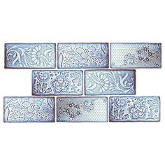 blue and white tile with flowers on the bottom, one is made from ceramic tiles