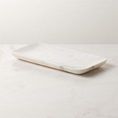 a white marble serving tray on a table