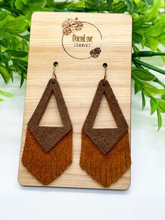 Brown Cognac Genuine Suede Leather Earrings Beautiful, lightweight triangle fringe earrings made of brown and cognac genuine suede leather.  The perfect Fall to Winter accessory, dress them down for the office or glam them up for a night on the town! Trendy, boho, and unique, these earrings are sure to make a statement with any outfit! Each pair is made to order and pattern placement may vary from pictured. Earring wires are made of surgical stainless steel with an antique bronze finish, making them hypoallergenic and great for sensitive ears.  Earring Features: * Genuine suede leather * Surgical stainless steel antique bronze ear wires with clear backs * Measures approximately 2.5 inches in length * Lightweight *Please Note: I try my best to capture the most accurate colors of materials. Elegant Brown Adjustable Tassel Earrings, Brown Fringed Tassel Earrings Gift, Brown Fringe Tassel Earrings For Gift, Brown Fringe Tassel Earrings As Gift, Brown Dangle Earrings With Tassels, Brown Fringe Dangle Jewelry, Suede Earrings, Earrings Triangle, Earring Wires