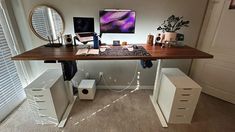 a desk with drawers and a computer on it