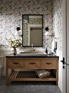 a bathroom with a sink and mirror in it