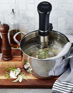 a large pot filled with food on top of a wooden cutting board