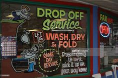 a store front window with signs on it and chairs in the foreground reading drop off service let us wash dry & fold