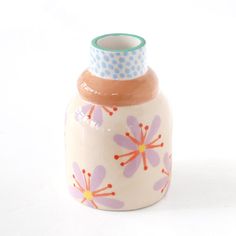 a ceramic vase with flowers painted on it