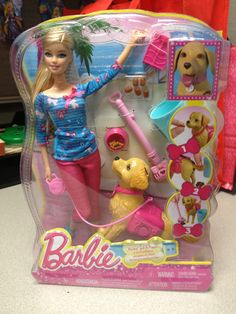 the barbie doll is playing with her dog