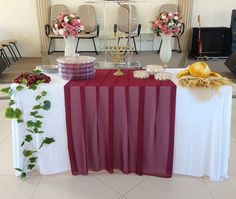 the table is set up with flowers and other items for an elegant wedding reception or special event