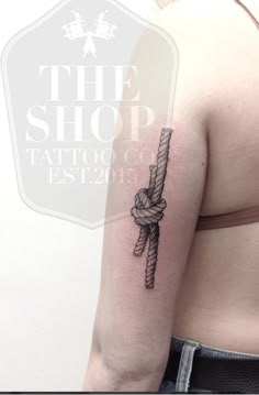 a woman's arm with a tattoo on it that has a rope attached to it