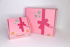 two pink boxes with bows on them sitting next to each other