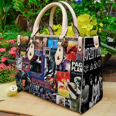 a handbag with many pictures on it sitting on a table next to some flowers