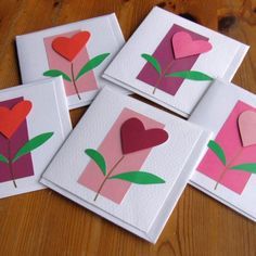 four cards with hearts and flowers on them