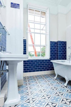 Primary Bathroom with Pedestal Sink, Clawfoot Tub, Blue Subway Tile Walls, and Framed Window Coastal Bathroom Design, Blue Subway Tile