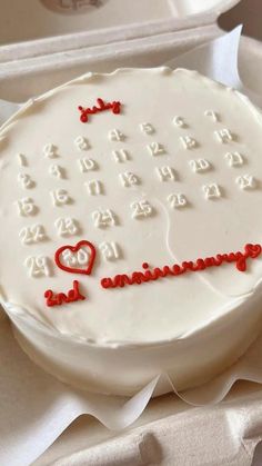 a white cake with red icing and numbers on it