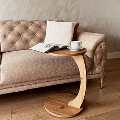 a coffee table with a book on it next to a couch